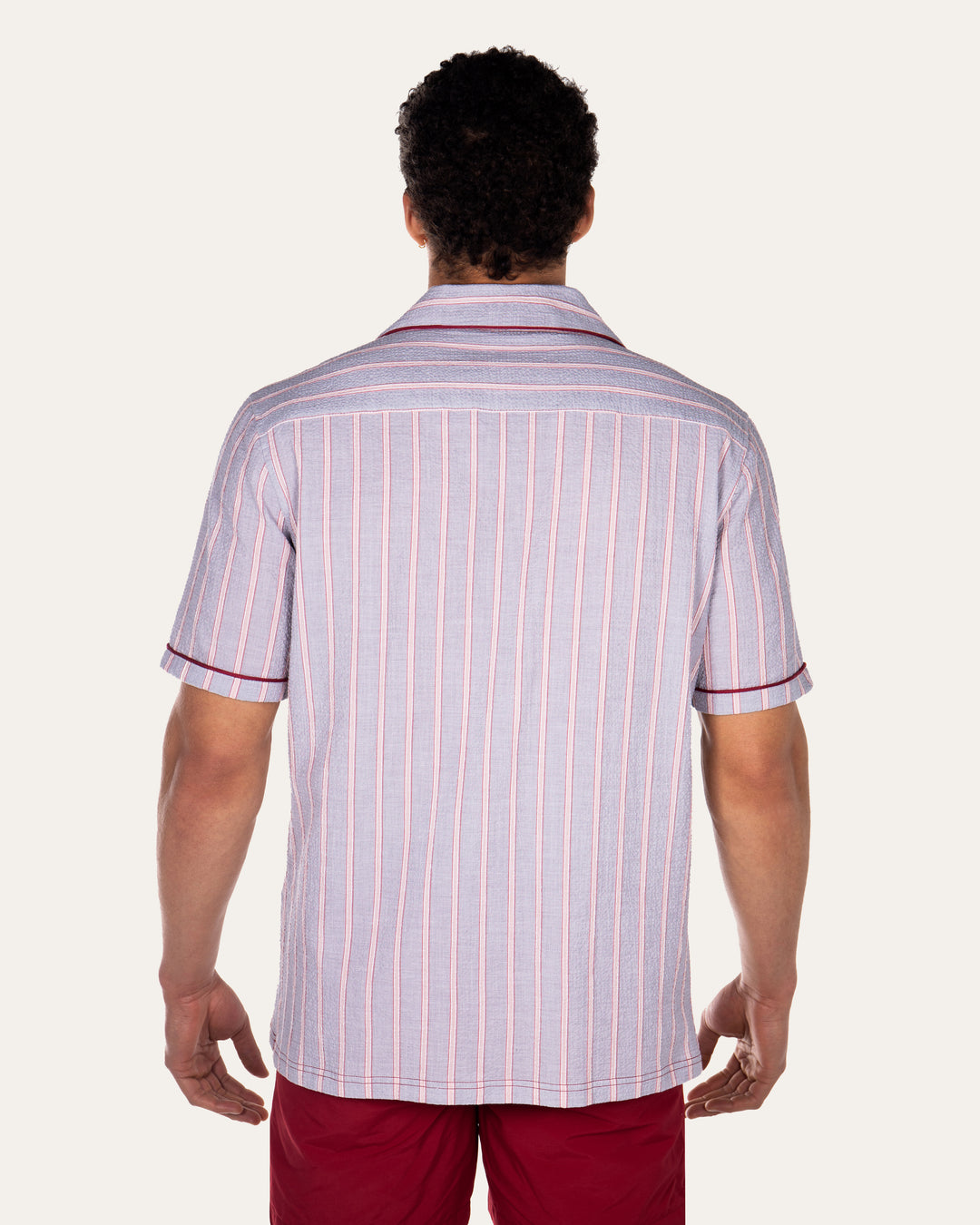 Luka Grey Shirt with Burgundy PipingCut from a breathable cotton seersucker fabric, the Luka  shirt is Inspired by the classic cuban shirt. Designed with a camp collar and burgundy contrasting piping.