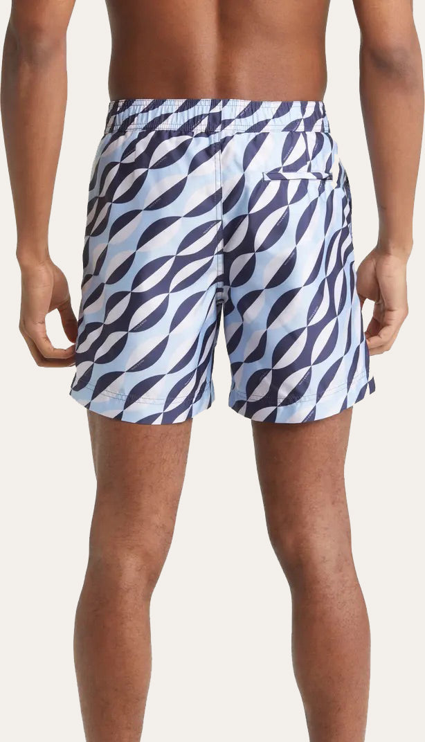 Model wearing Easton Blue and White Geometric print swim shorts by Prince & Bond rare view