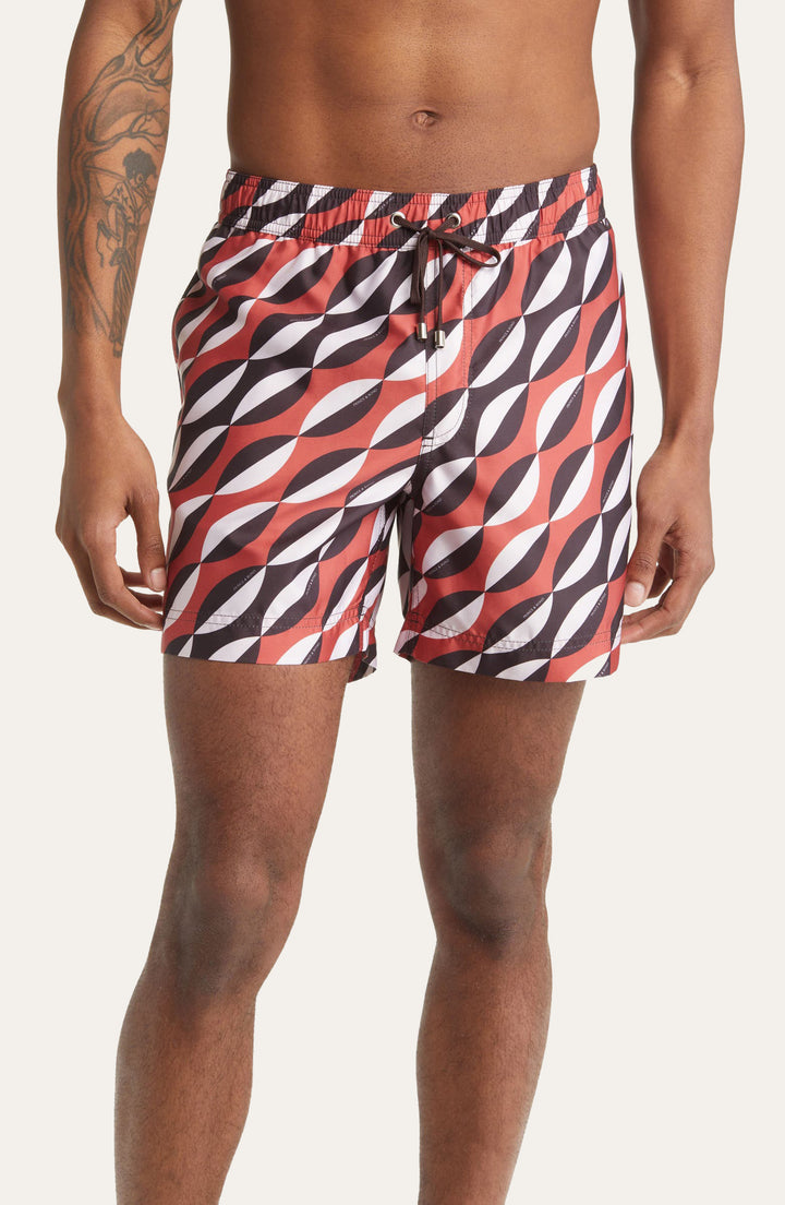Model wearing Easton Geometric print swim shorts by Prince & Bond in Multicolor