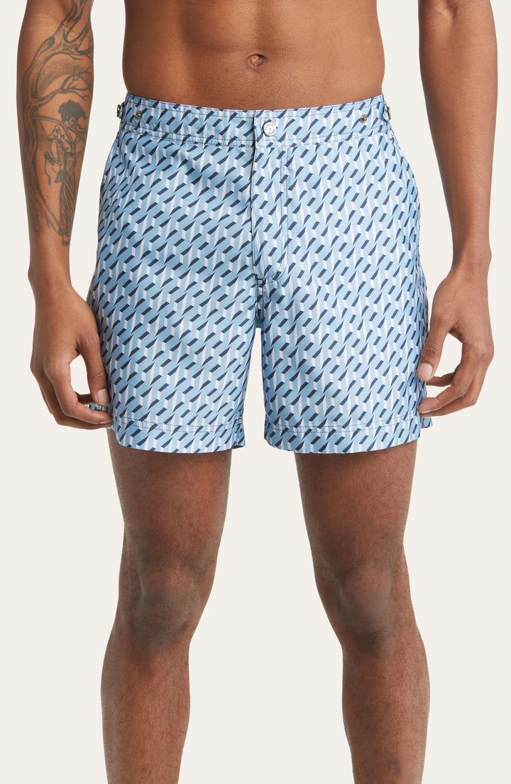 Model wearing Elvio Blue and White Sorrento print tailored swim shorts by Prince & Bond