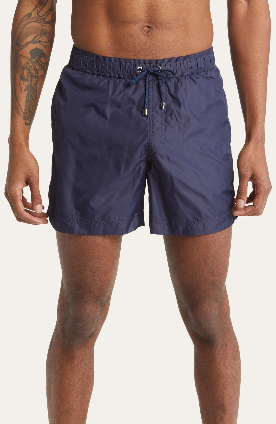 Model wearing navy blue Easton Logo Embroidered tailored swim shorts by Prince & Bond