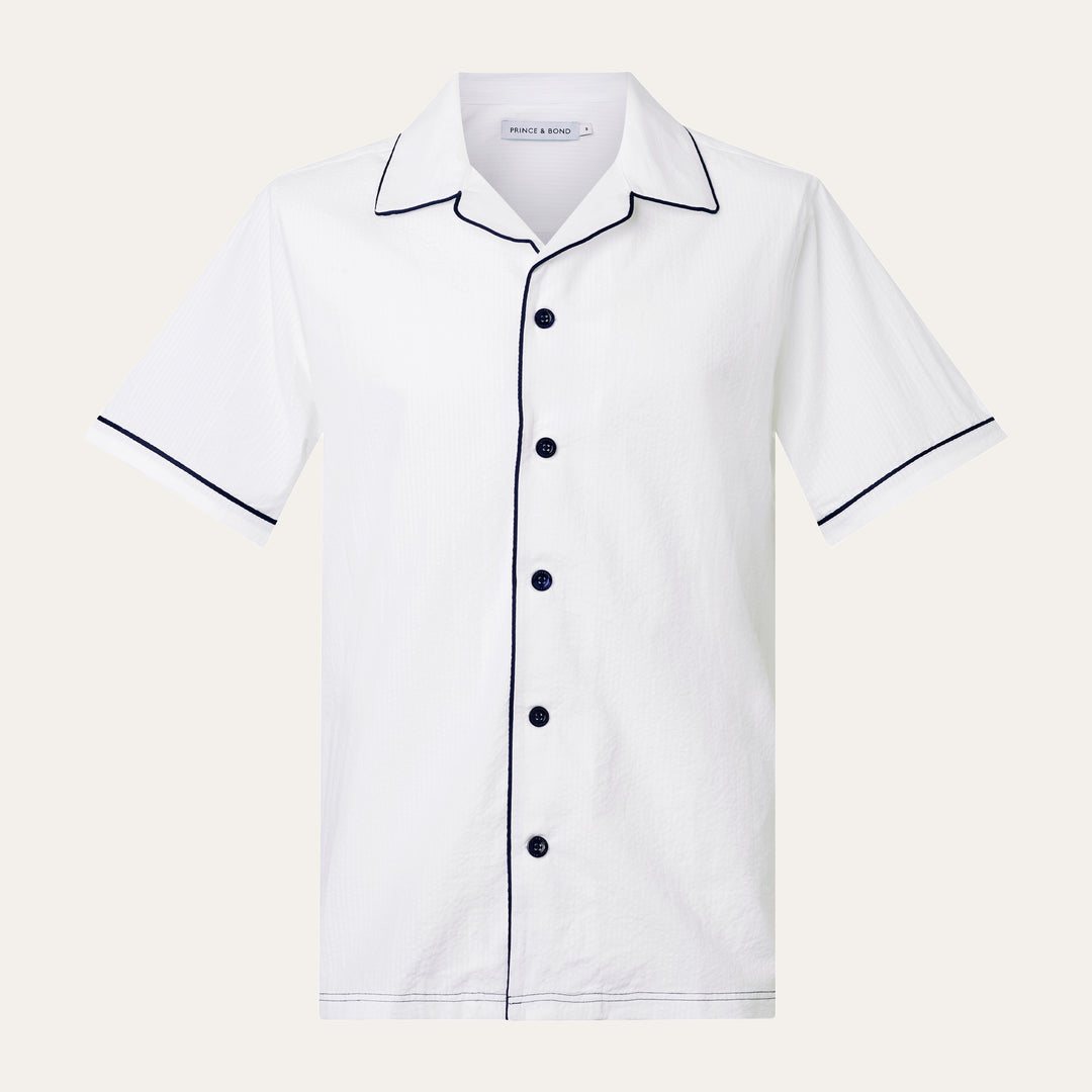 Luka Camp Collar Shirt with navy piping
Cut from a white breathable cotton seersucker fabric.