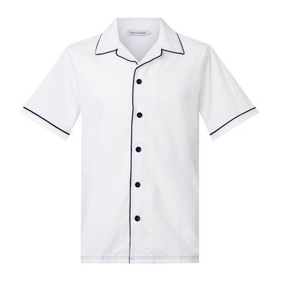 Luka Camp Collar Shirt with navy piping
Cut from a white breathable cotton seersucker fabric, the Luka  shirt is Inspired by the classic cuban shirt. Designed with a camp collar and blue contrasting pipin